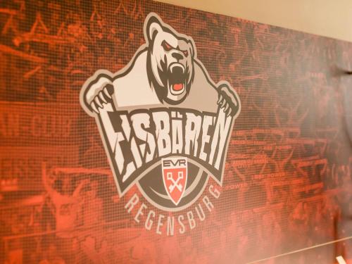 a sign on a wall with a bear on it at ibis Regensburg Zentrum in Regensburg