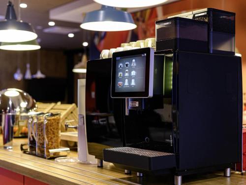 a coffee machine sitting on top of a counter at ibis Regensburg Zentrum in Regensburg