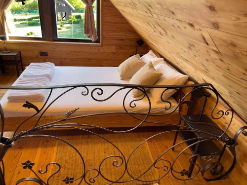 a bed in a room with a wooden wall at Ozoni & Spa in Sopot
