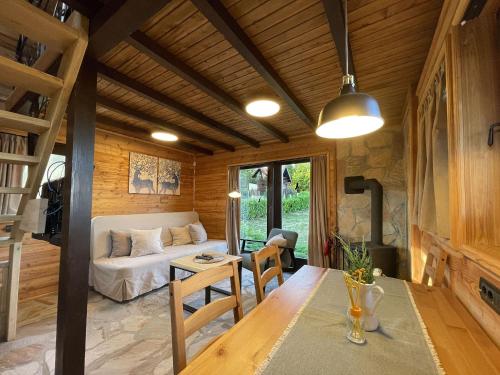 a room with a bed and a table and a couch at Ozoni & Spa in Sopot
