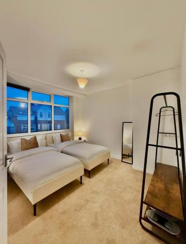 a bedroom with two beds and a ladder in it at Stockport Stays in Stockport