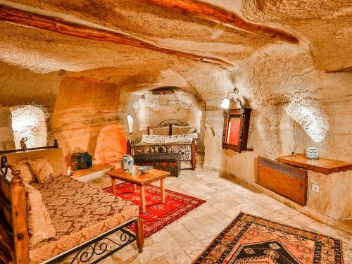 a large room with a bed and a table at Castle Inn Cave Cappadocia in Ortahisar