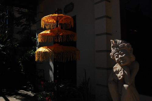 a statue in front of a building with a light at Beachfront Villa Jepun Segara in Banjar