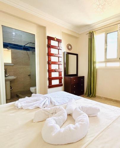 a bedroom with a large bed with towels on it at Giza Pyramids View Guest House in Cairo