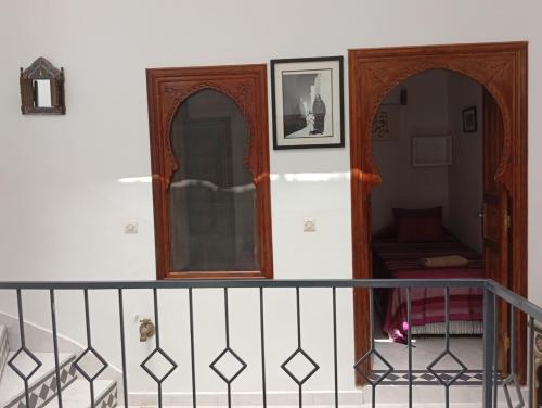 a room with a staircase with twomirror doors and a shelf at Ryad Ayad in Marrakech