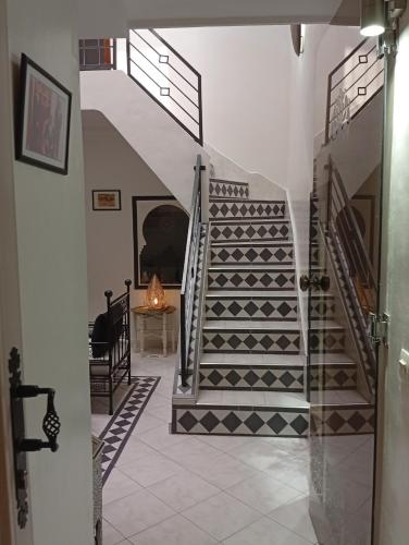 a hallway with stairs and a table in a room at Ryad Ayad in Marrakech