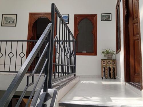 a staircase in a home with wooden doors at Ryad Ayad in Marrakech
