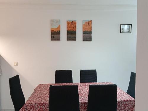 a dining room with a table and four chairs at Ryad Ayad in Marrakech