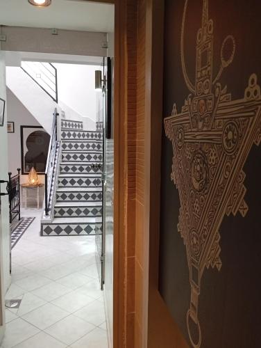 a hallway with a cross painted on the wall at Ryad Ayad in Marrakech