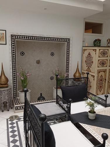 a living room with a mirror and a chair at Ryad Ayad in Marrakech