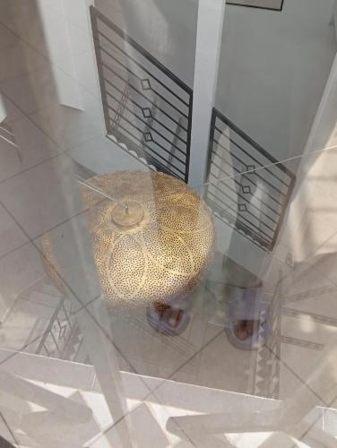 a glass display with a large gold peacock at Ryad Ayad in Marrakech