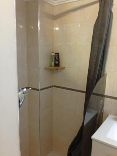 a shower with a glass door in a bathroom at Ryad Ayad in Marrakech