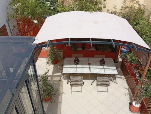an overhead view of a patio with a table and chairs at Ryad Ayad in Marrakech