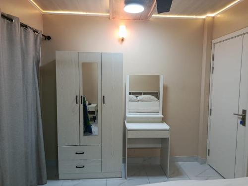 a bathroom with a white cabinet and a mirror at Portia beach grand 2 in Male City