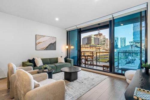 a living room with a couch and a large window at Luxe 3BR CBD Apartment with River Views and Resort Style Amenities in Melbourne
