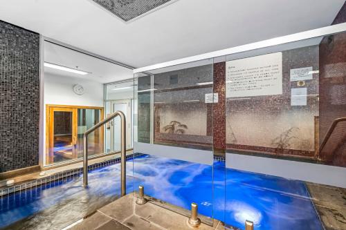 a swimming pool with blue water in a building at Luxe 3BR CBD Apartment with River Views and Resort Style Amenities in Melbourne