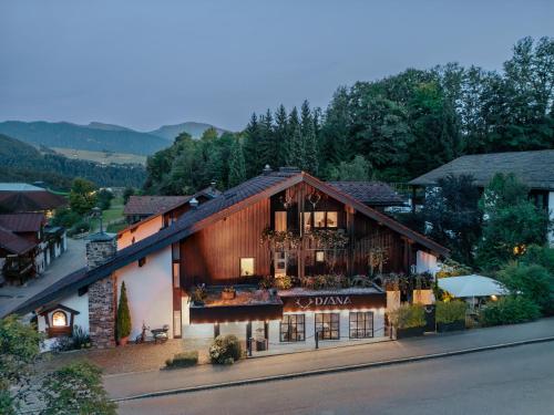 a building with a balcony with flowers on it at DIANA Naturpark Hotel - Partnerbetrieb von "Oberstaufen PLUS GOLF" in Oberstaufen