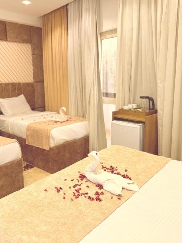 a hotel room with two beds and flowers on the bed at Locanda pyramids view in Cairo