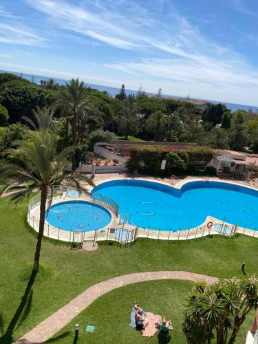 an overhead view of a swimming pool in a resort at Marbella Beach View and Pool in Marbella