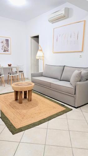 a living room with a couch and a coffee table at YouGa Nest in Vívlos