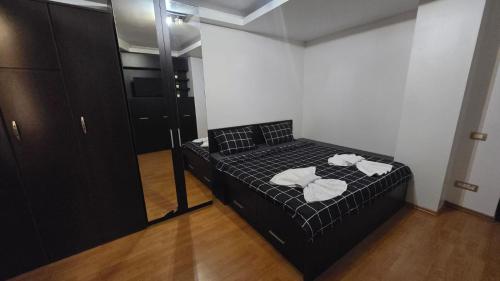 a bedroom with a bed with two towels on it at Terrace & Comfort Residence- SELF CHECK-IN in Bucharest