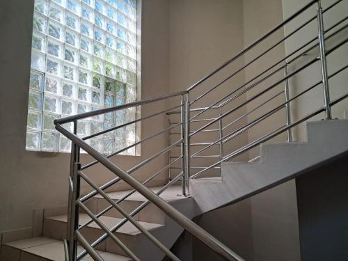 a metal staircase in a building with a window at SeaXplore Lodge & Dive Center in Sodwana Bay