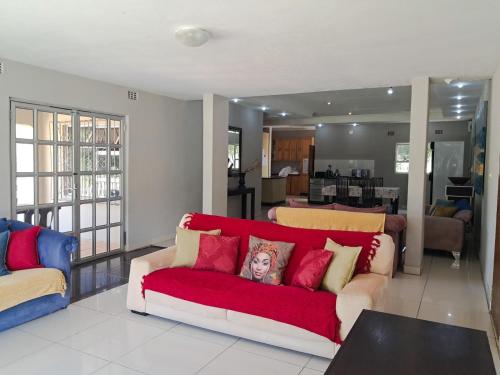 a living room with a couch with a picture on it at SeaXplore Lodge & Dive Center in Sodwana Bay