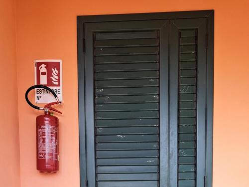 a fire hydrant next to a door with a fire hydrant next to at Casa Concetta in Noto Marina