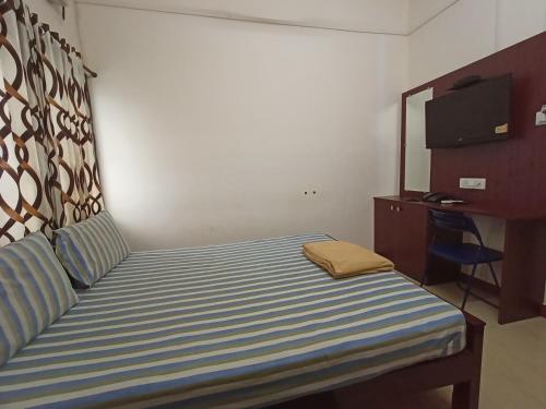 Cama o camas de una habitación en Aditya Residency