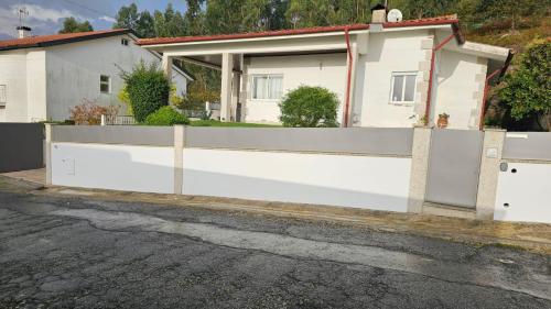 a white fence in front of a house at Lar do Sossego in Geme