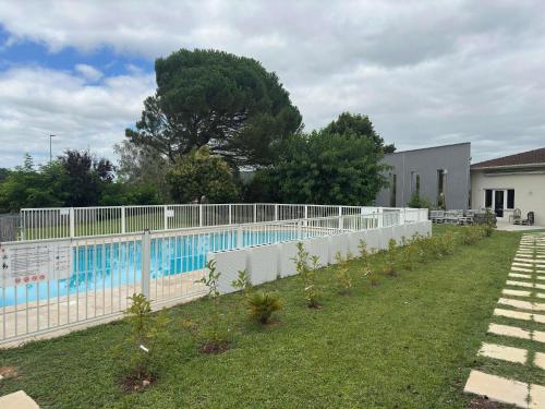 a swimming pool with a fence around it at ibis Cahors in Cahors