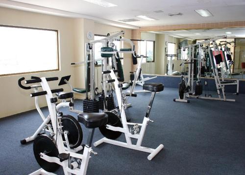 a gym with several tread machines in a room at Hotel San Marcos Grand in Culiac&aacute;n