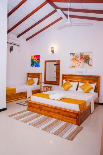 a bedroom with two beds in a room at The Mango House Ahangama in Ahangama