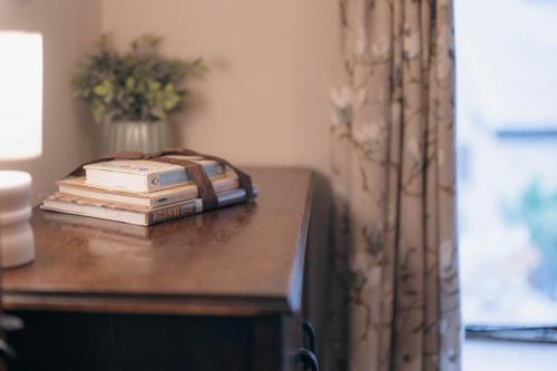 a telephone sitting on top of a table with books at The Shippon Barn - A delightful haven for families in Wirral