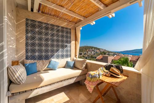 a couch on a balcony with a view at Elixir Hotel in Kalkan