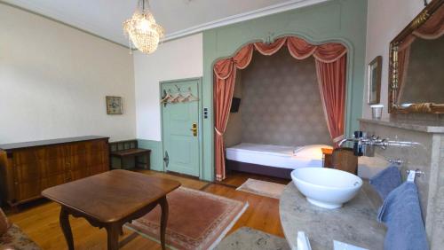 a living room with a bed and a table at Boardinghouse Sonne in Offenburg