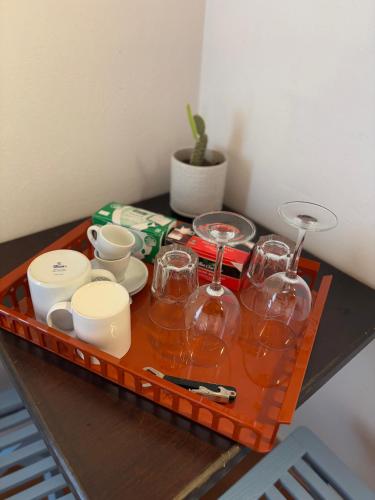 a tray with wine glasses and dishes on a table at Villa Donna Sibilla in Merine