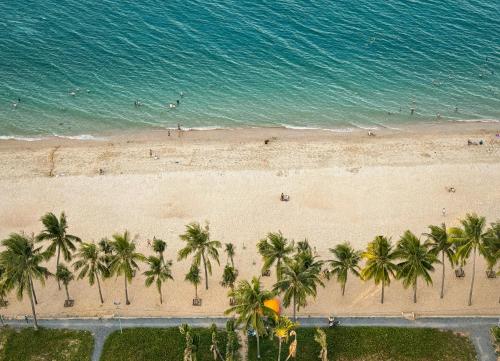 an overhead view of a beach with palm trees and the ocean at VELA OCEAN LUXURY SUITES Nha Trang Centre in Nha Trang