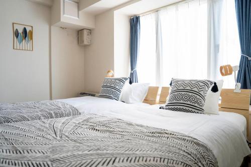 Postel nebo postele na pokoji v ubytování ダイナスティパレス58