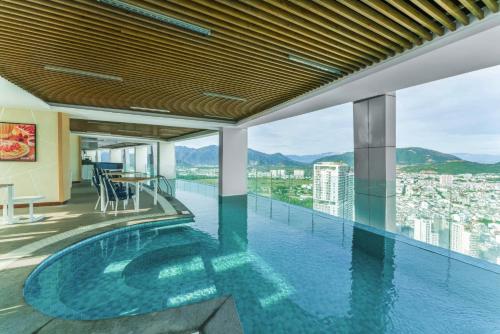 a pool on the roof of a building with a view at VELA OCEAN LUXURY SUITES Nha Trang Centre in Nha Trang