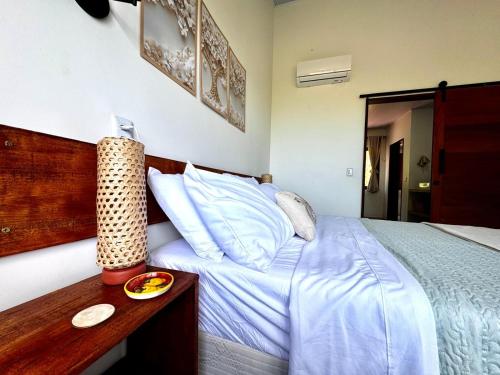 a bedroom with a bed and a table with a plate on it at Casa Amor With Sea View in Goiana