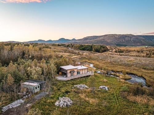an aerial view of a house in the middle of a field at Riverside Cabin - Hot Tub, Fishing and Relaxing Escape in Laugarvatn