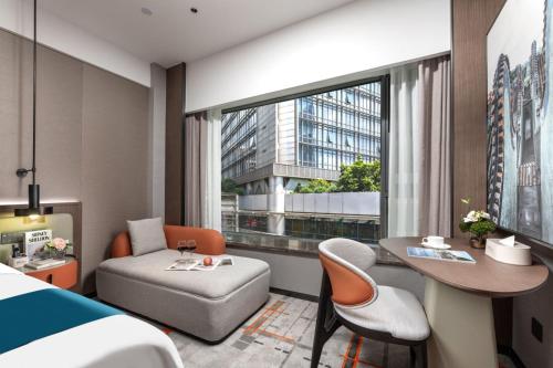 Ένα ή περισσότερα κρεβάτια σε δωμάτιο στο Huankai Hotel Guangzhou Book Center Tiyuxi Road Subway Station Branch