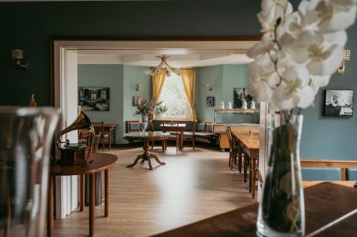 a room with tables and chairs and a dining room at Alpenstadthotels in Bad Reichenhall