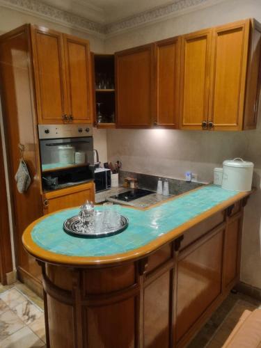 a kitchen with a counter with a blue counter top at Palmeraie village , lieu exceptionnel avec jardin et piscine in Marrakech