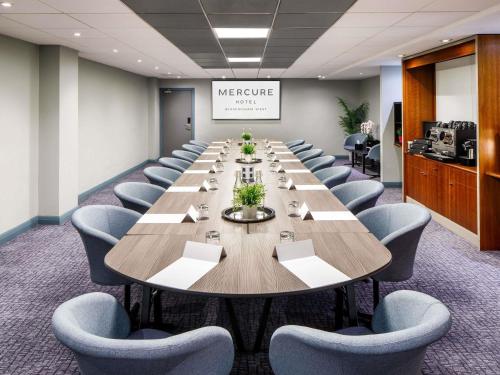 a large conference room with a long table and chairs at Mercure Birmingham West Hotel in West Bromwich