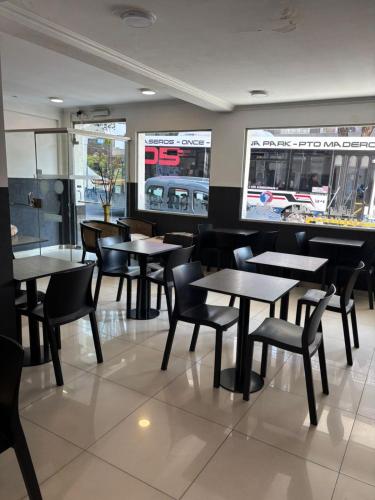 a dining room with tables and chairs in a restaurant at Aires Express in Buenos Aires