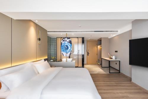 Postel nebo postele na pokoji v ubytování Guangzhou Xingdu International Hotel