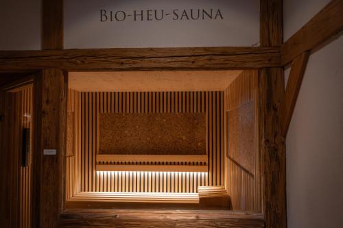 a wooden door with a sign that reads do hog sauna at Alpenstadthotels in Bad Reichenhall