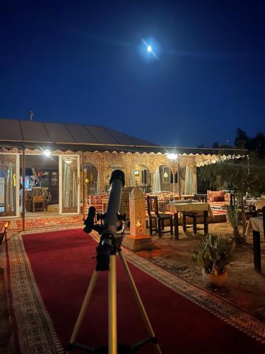 a camera on a tripod in front of a building at Sahara Majestic Luxury Camp in Merzouga